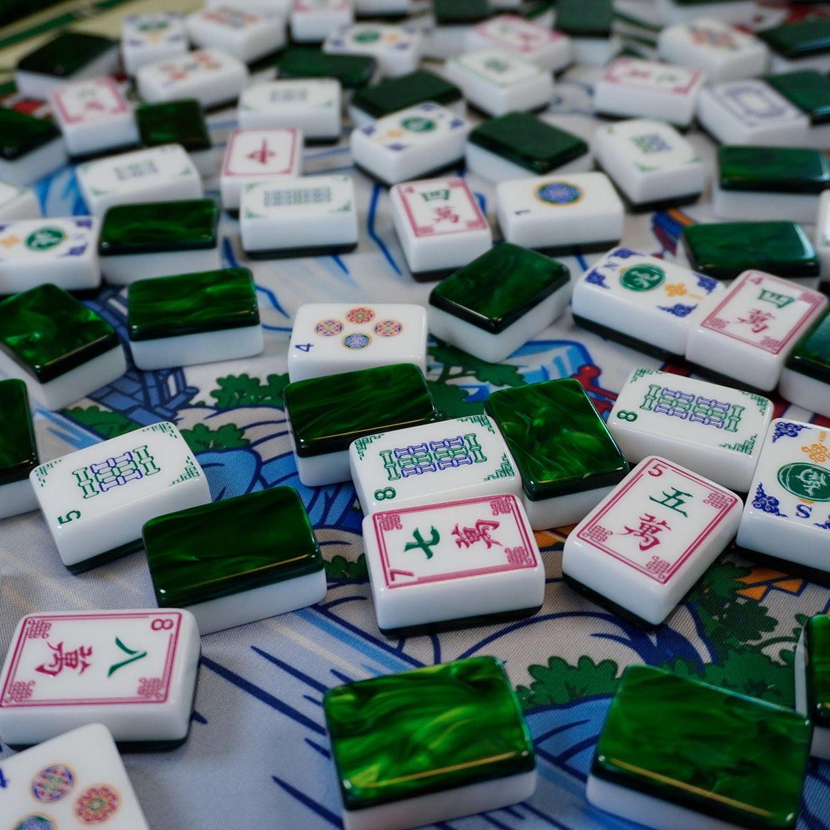 Legacy Emerald Edition tiles scattered across a mahjong mat