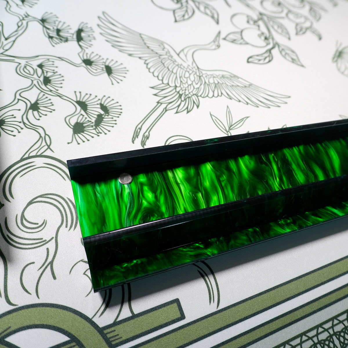 Emerald acrylic rack resting on the Jade Garden Mahjong Mat