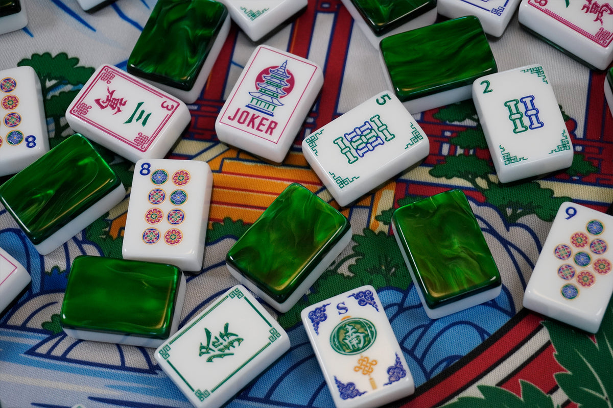Legacy Emerald Edition tiles scattered on a mahjong mat